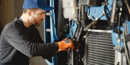 Mechanic apprentice working on machinery